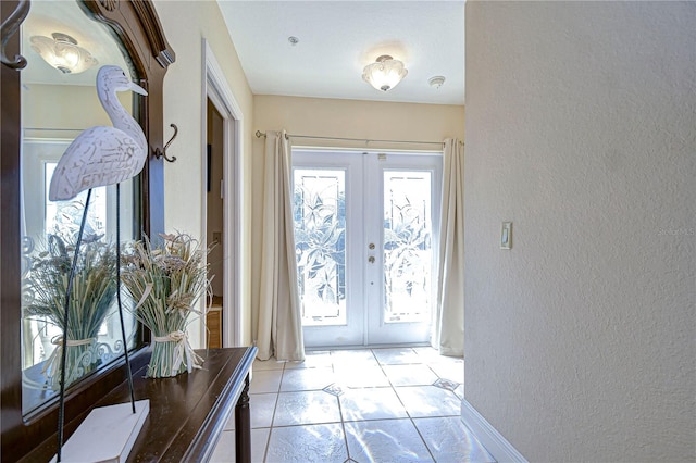 6801 Nowiki Ave, Hudson, FL 34667 - entryway with baseboards, a textured wall, french doors, and light tile patterned floors