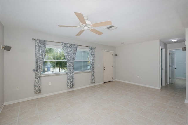 spare room featuring light tile patterned flooring and ceiling fan