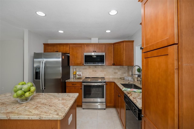 kitchen featuring sink, light tile patterned floors, stainless steel appliances, light stone counters, and tasteful backsplash