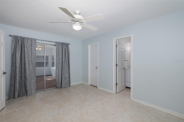 tiled empty room with ceiling fan