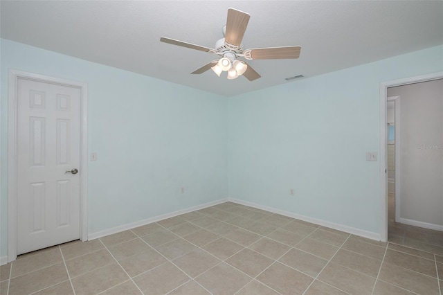 spare room with light tile patterned floors and ceiling fan