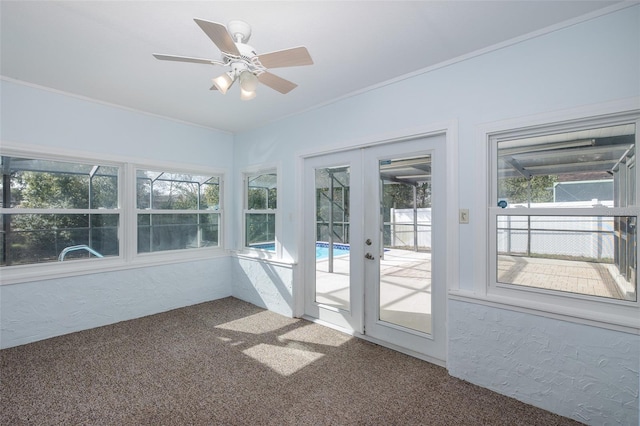 unfurnished sunroom with french doors and ceiling fan