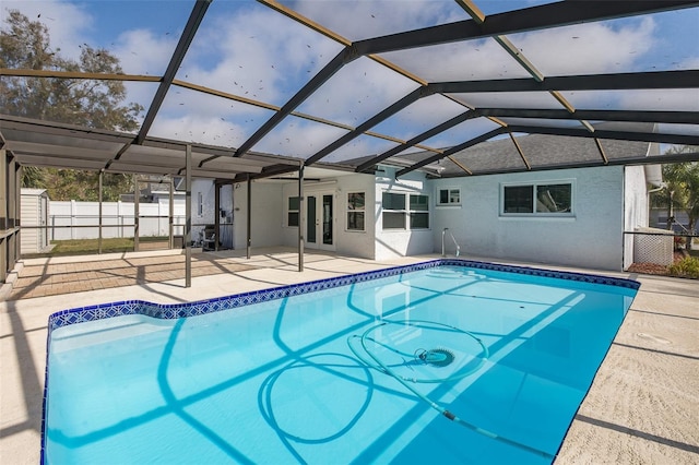 view of swimming pool featuring a patio, a lanai, and french doors