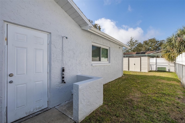 exterior space with cooling unit, a lawn, and a storage unit