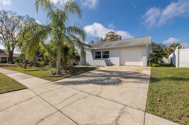 ranch-style house featuring a garage and a front lawn