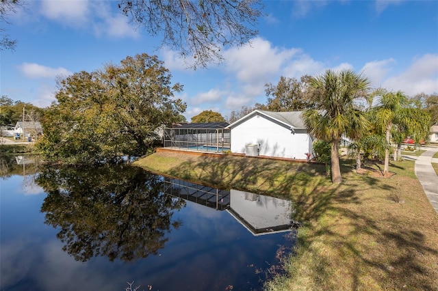 exterior space featuring a water view, a lanai, and a yard