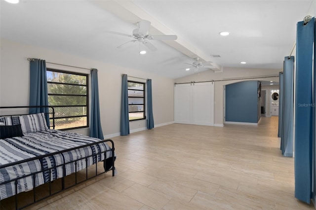 bedroom featuring ceiling fan, a barn door, and lofted ceiling with beams