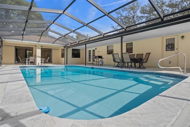 view of swimming pool featuring a patio and glass enclosure