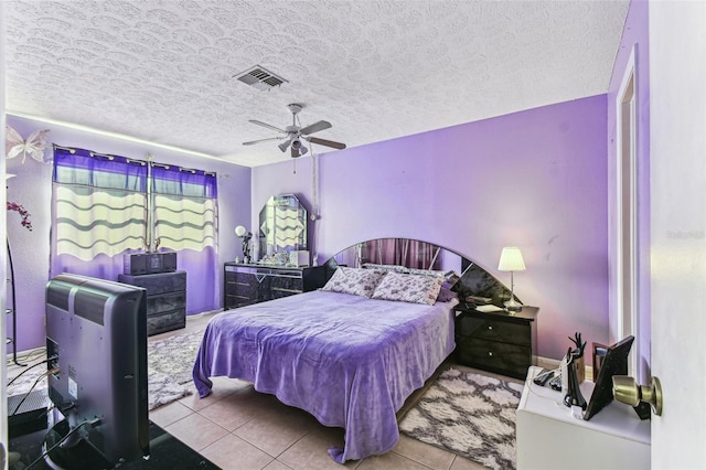 bedroom featuring light tile patterned floors, a textured ceiling, and ceiling fan