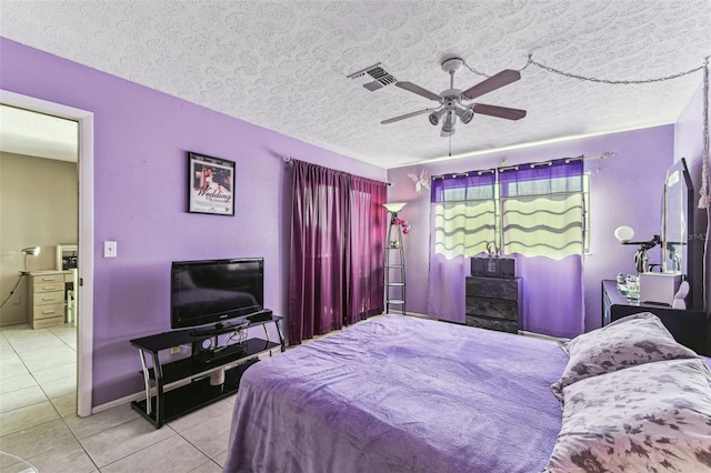 tiled bedroom featuring ceiling fan and a textured ceiling