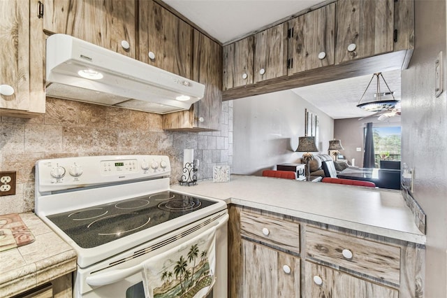 kitchen featuring white electric stove and tasteful backsplash