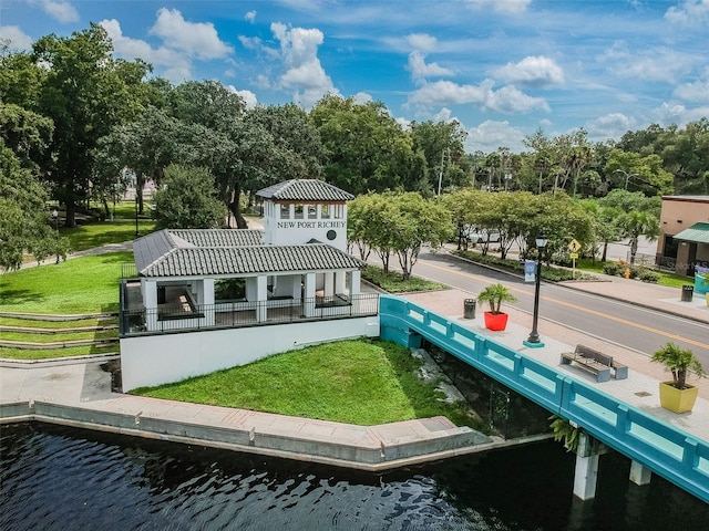 view of community with a yard and a water view