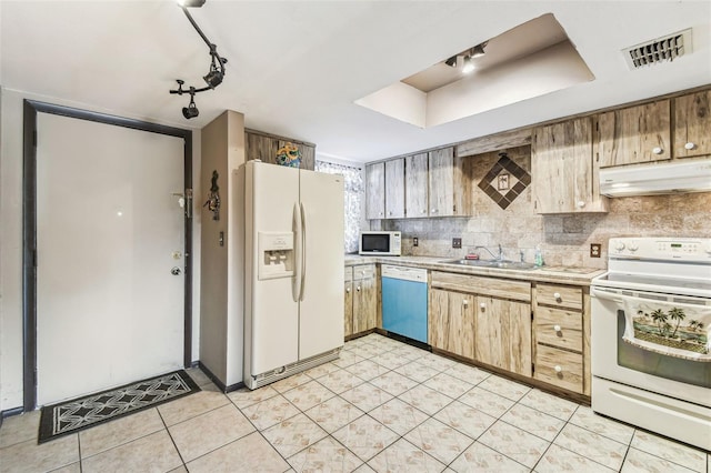 kitchen featuring sink, decorative backsplash, light tile patterned floors, a raised ceiling, and white appliances