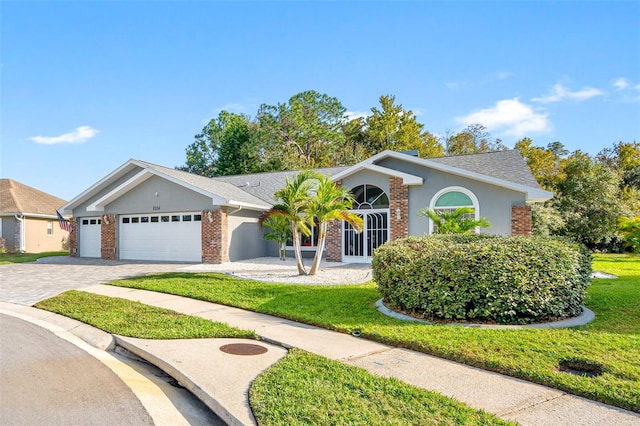 single story home with a garage and a front lawn