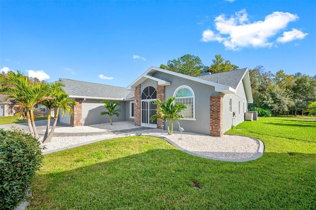 ranch-style home with a garage and a front lawn