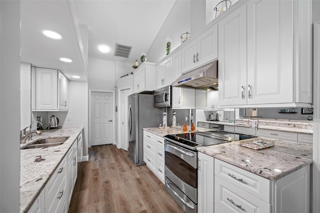 kitchen featuring sink, stainless steel appliances, white cabinets, and light stone countertops