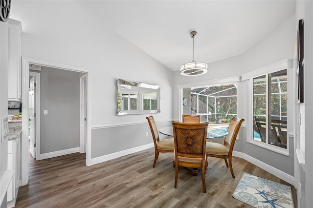 dining room with lofted ceiling and hardwood / wood-style floors