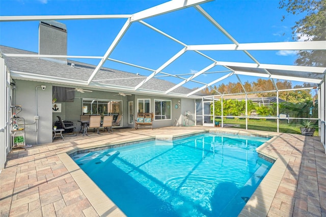 view of swimming pool with a patio area and glass enclosure