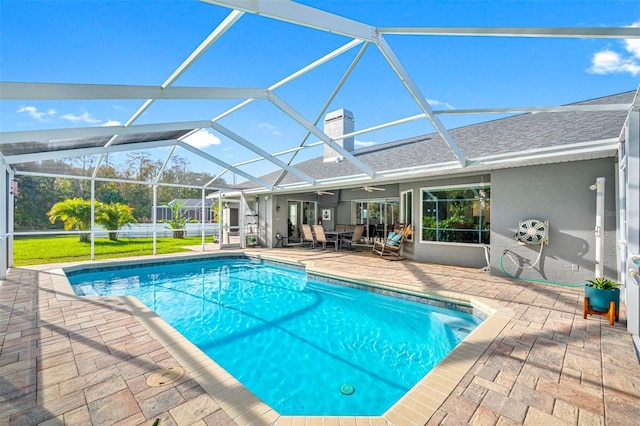 view of swimming pool featuring a patio area and glass enclosure