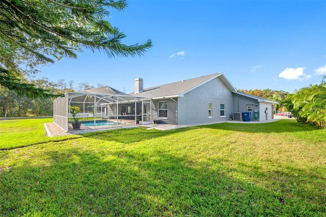 rear view of property featuring a yard, cooling unit, and glass enclosure