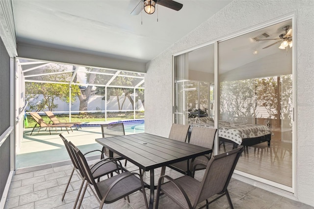 sunroom / solarium with ceiling fan and lofted ceiling