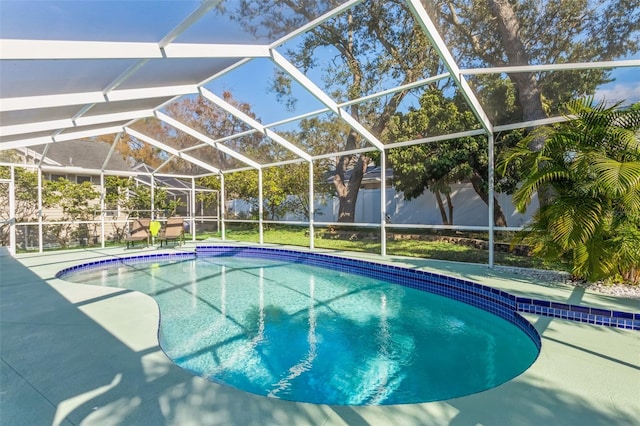 view of pool with glass enclosure