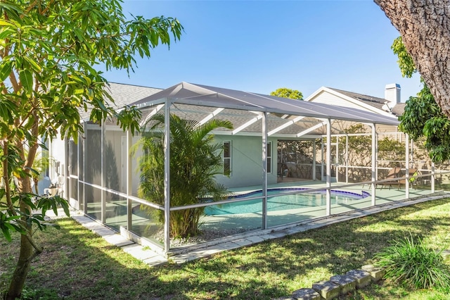 view of pool with a patio, a lanai, and a yard