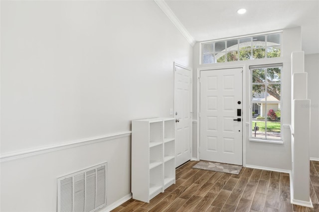 foyer with hardwood / wood-style flooring and ornamental molding