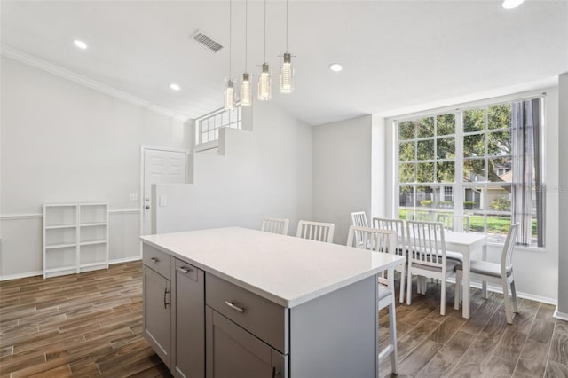 kitchen with plenty of natural light, a center island, pendant lighting, and gray cabinetry