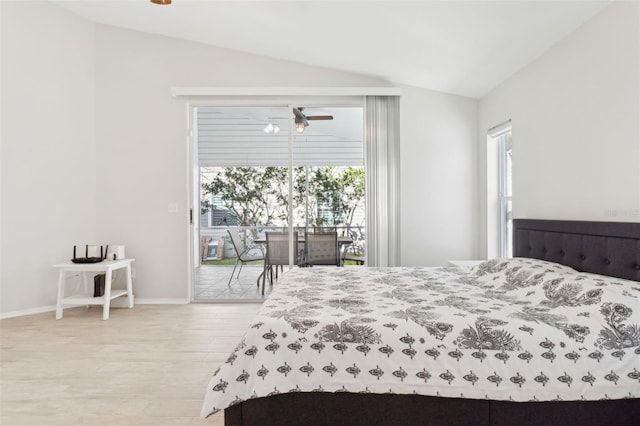 bedroom with wood-type flooring, access to exterior, vaulted ceiling, and multiple windows