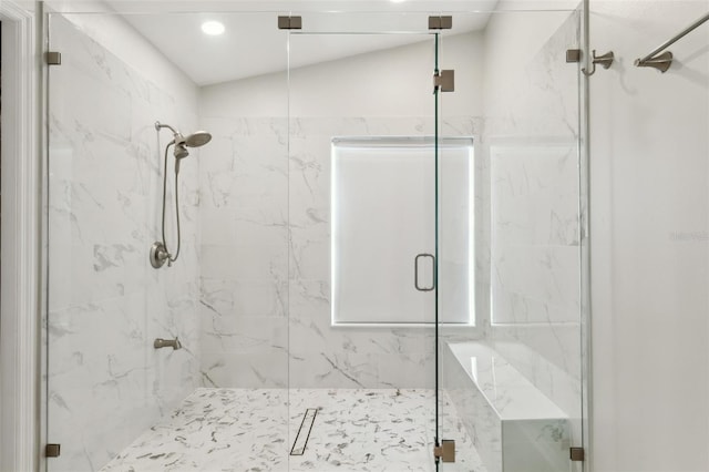 bathroom featuring vaulted ceiling and walk in shower