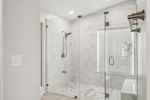 bathroom with toilet and an enclosed shower