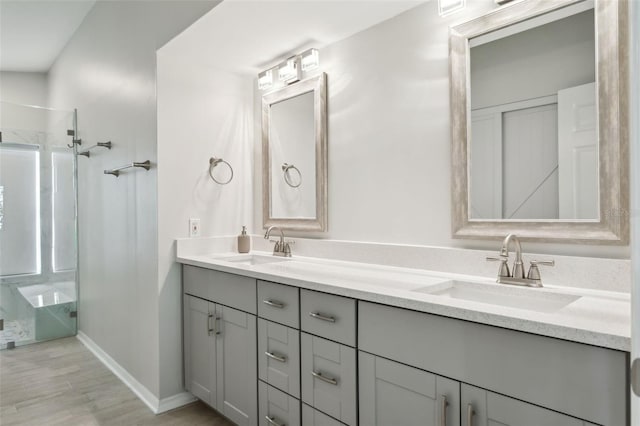 bathroom featuring vanity, a shower, and hardwood / wood-style floors