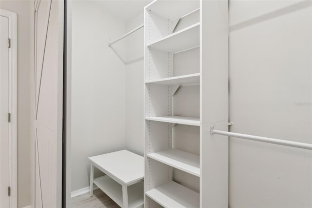 spacious closet with light hardwood / wood-style floors