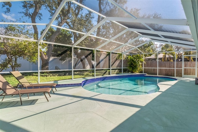 view of swimming pool with a lanai and a patio area