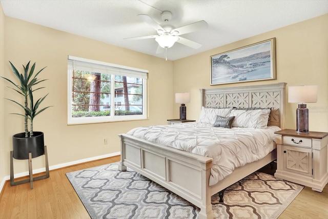 bedroom with ceiling fan and light hardwood / wood-style floors