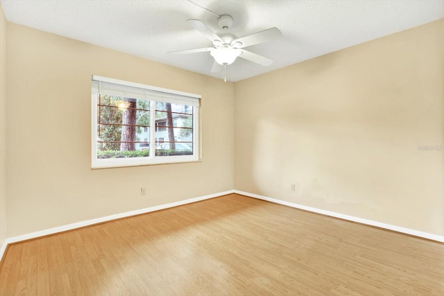 spare room featuring ceiling fan, light hardwood / wood-style floors, and a textured ceiling