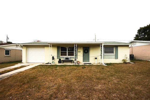 single story home with a garage, covered porch, central air condition unit, and a front lawn