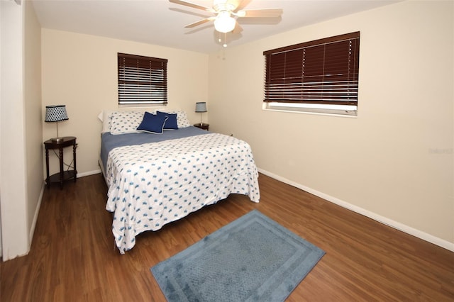 bedroom with ceiling fan and dark hardwood / wood-style flooring