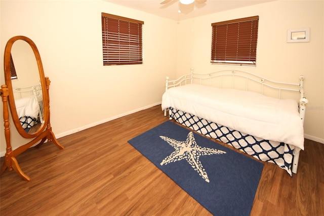 bedroom featuring ceiling fan and dark hardwood / wood-style flooring