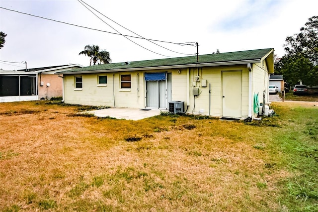 rear view of property featuring a patio and a yard