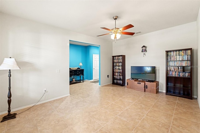 unfurnished living room with visible vents, ceiling fan, baseboards, and light tile patterned flooring