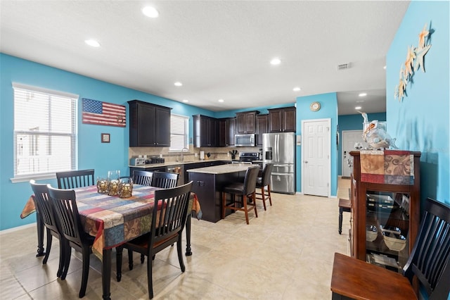 dining space featuring baseboards, light tile patterned floors, visible vents, and recessed lighting