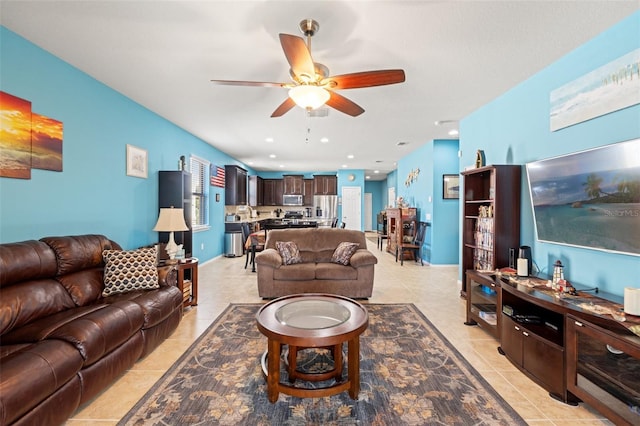 living room with a ceiling fan, recessed lighting, and light tile patterned floors