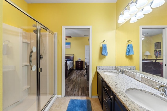 full bath featuring a sink, tile patterned floors, ensuite bath, and a shower stall