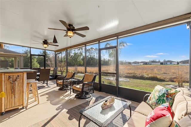 sunroom with a ceiling fan