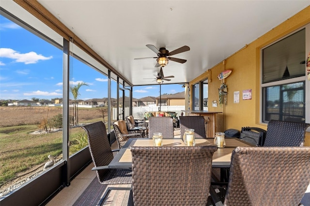 sunroom / solarium featuring a ceiling fan