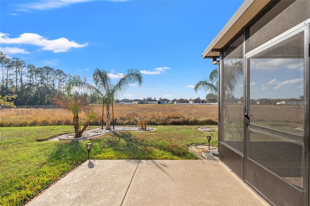 view of yard with a patio area and a rural view