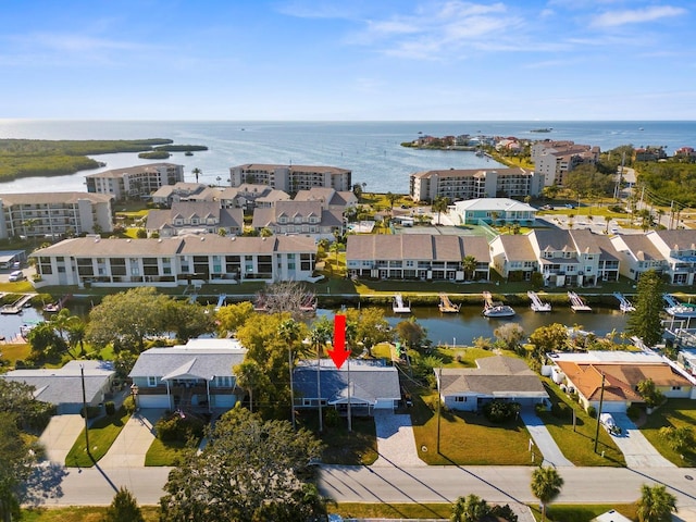 birds eye view of property with a water view and a residential view