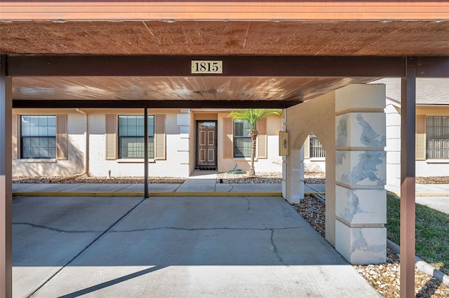 doorway to property with a carport